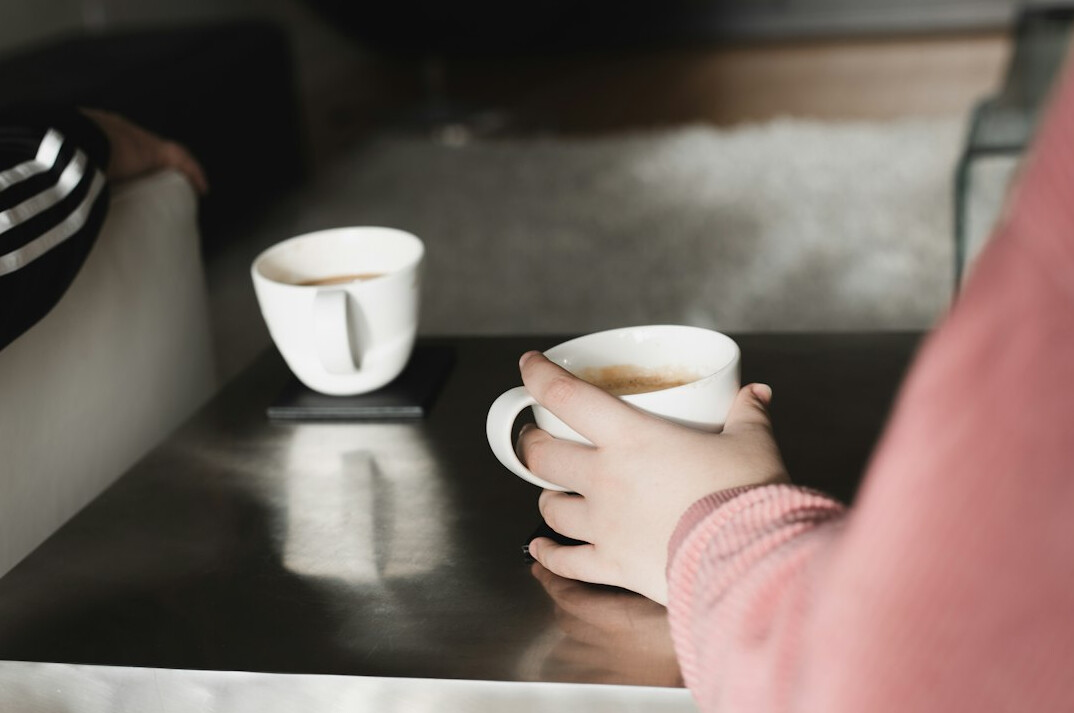 Two Brazilian colleagues having a friendly conversation over coffee