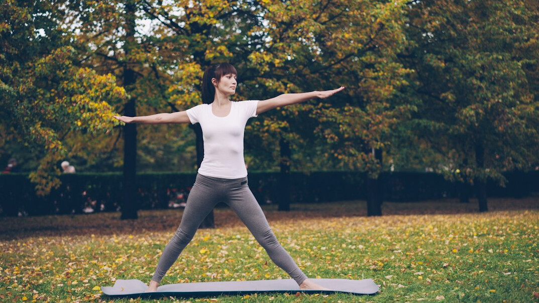 woman doing yoga in park